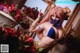 A woman in a bikini posing in front of a bunch of flowers.