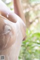 A close up of a woman's breasts covered in water.