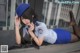 A woman in a police uniform laying on a ledge.