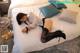 A woman laying on a bed in a hotel room.