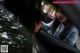 A woman looking out the window of a car at another woman.