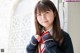 A young woman in a school uniform posing for a picture.